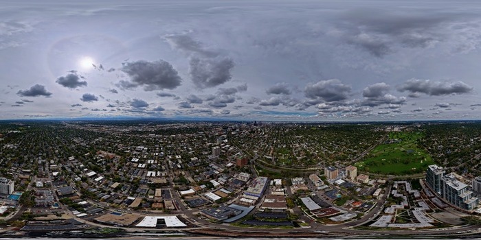 Aerial view of the Cherry Creek neighborhood with residential buildings lush green spaces and the city skyline under a cloudy sky in Denver Colorado United States. Aerial view of the Cherry Creek neighborhood with residential buildings lush green spaces and the city skyline under a cloudy sky in Denver Colorado United States.