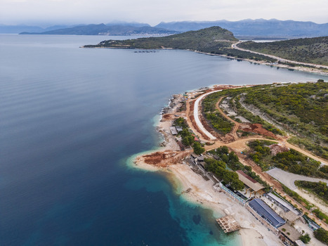 Aerial view of the coastline of Ksamil with turquoise waters sandy beach and ongoing construction work along the shore in Ksamil Vlore County Albania. Aerial view of the coastline of Ksamil with turquoise waters sandy beach and ongoing construction work along the shore in Ksamil Vlore County Albania.
