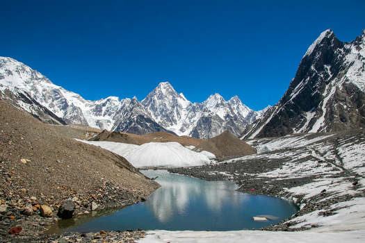 View of Gasherbrum IV peak and a glacial lake reflecting the clear blue sky in the Karakoram range Skardu Gilgit Pakistan. View of Gasherbrum IV peak and a glacial lake reflecting the clear blue sky in the Karakoram range Skardu Gilgit Pakistan.
