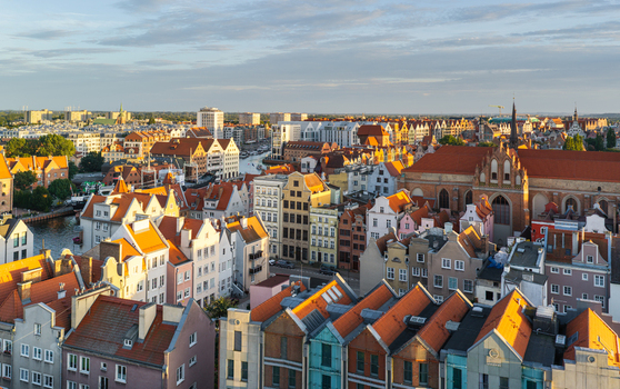 Aerial view of the historic city center of Gdansk with colorful gabled houses red tiled roofs and the Motlawa River in Gdansk Pomeranian Voivodeship Poland. Aerial view of the historic city center of Gdansk with colorful gabled houses red tiled roofs and the Motlawa River in Gdansk Pomeranian Voivodeship Poland.