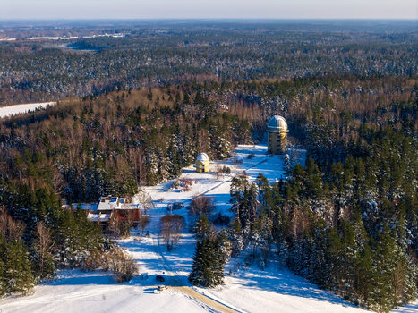 Aerial view of Moletai Astronomical Observatory with white domes nestled among snow covered pine trees and a vast winter forest Kulionys Utenos apskritis Lithuania. Aerial view of Moletai Astronomical Observatory with white domes nestled among snow covered pine trees and a vast winter forest Kulionys Utenos apskritis Lithuania.