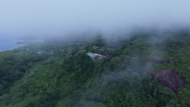 Aerial view of building complex in lush forest Seychelles.