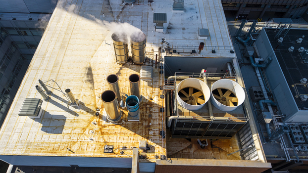 Aerial view of industrial HVAC equipment and cooling towers on the rooftop of a building in Kendall Square Cambridge Massachusetts United States. Aerial view of industrial HVAC equipment and cooling towers on the rooftop of a building in Kendall Square Cambridge Massachusetts United States.