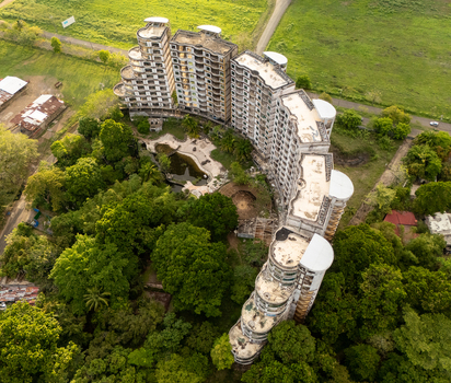 Aerial view of the abandoned Sonesta One Resort complex surrounded by lush tropical forest in Jaco Provincia de Puntarenas Costa Rica. Aerial view of the abandoned Sonesta One Resort complex surrounded by lush tropical forest in Jaco Provincia de Puntarenas Costa Rica.