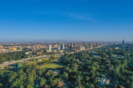 Aerial view of Westlands district skyline with modern high rise buildings elevated highway infrastructure and lush green trees in Nairobi Nairobi County Kenya. Aerial view of Westlands district skyline with modern high rise buildings elevated highway infrastructure and lush green trees in Nairobi Nairobi County Kenya.