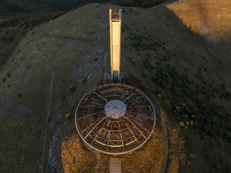 Aerial view of the Buzludzha Monument a brutalist structure with a circular roof and tall tower situated on a mountain peak in Stara Zagora Bulgaria. Aerial view of the Buzludzha Monument a brutalist structure with a circular roof and tall tower situated on a mountain peak in Stara Zagora Bulgaria.