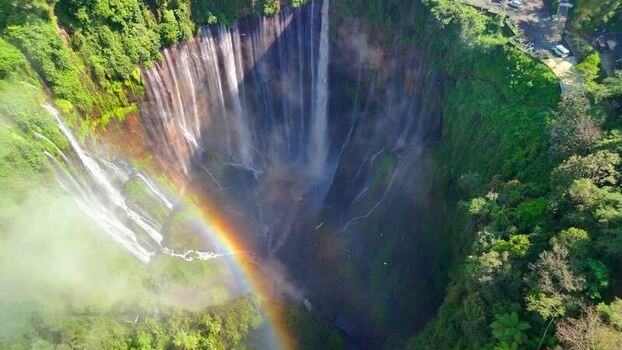 Aerial view of Tumpak Sewu Waterfall with a rainbow Indonesia.