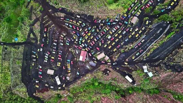Aerial view of off road jeeps on volcanic soil in Indonesia.