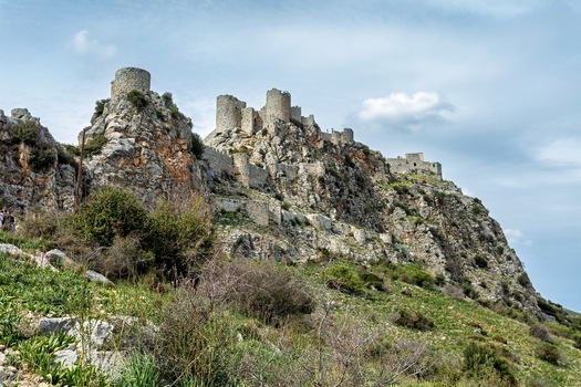 View of Serpent Castle perched on a rocky cliff with historic stone walls and towers surrounded by green vegetation in Adana Turkey. View of Serpent Castle perched on a rocky cliff with historic stone walls and towers surrounded by green vegetation in Adana Turkey.