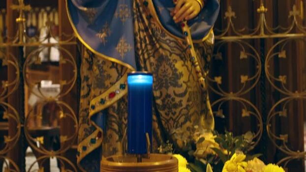 View of a religious statue with a blue candle in Australia.