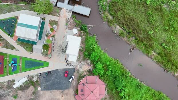 Aerial view of urban park with river and buildings Indonesia.