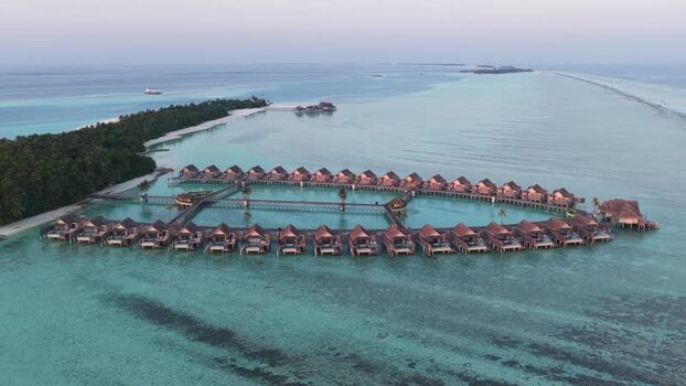 Aerial view of overwater bungalows at a luxury resort Maldives. Aerial view of overwater bungalows at a luxury resort Maldives.