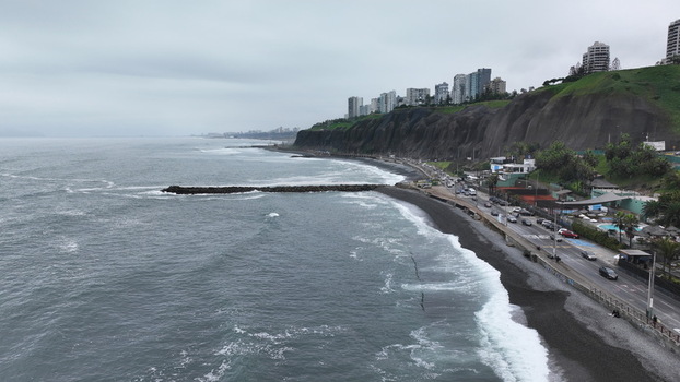 Aerial view of the Costa Verde coastline with high cliffs modern apartment buildings a coastal road and the Pacific Ocean in Barranco Provincia de Lima Peru. Aerial view of the Costa Verde coastline with high cliffs modern apartment buildings a coastal road and the Pacific Ocean in Barranco Provincia de Lima Peru.