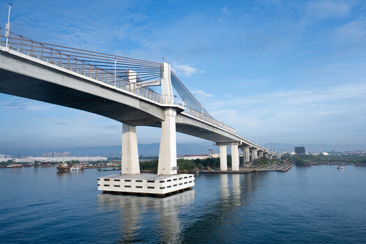 View of the Marcelo B. Fernan bridge spanning the water with concrete pylons and cable stayed architecture under a clear blue sky in Cebu City Central Visayas Philippines. View of the Marcelo B. Fernan bridge spanning the water with concrete pylons and cable stayed architecture under a clear blue sky in Cebu City Central Visayas Philippines.