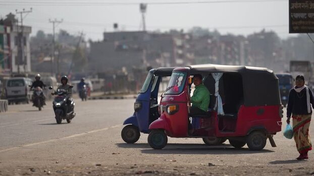 View of auto rickshaws and street traffic in Dhangadhi Nepal. View of auto rickshaws and street traffic in Dhangadhi Nepal.