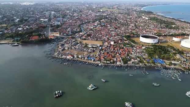 Aerial view of Cilacap coastal town and fishing boats Indonesia. Aerial view of Cilacap coastal town and fishing boats Indonesia.