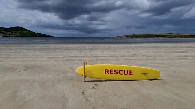 View of a yellow rescue surfboard on the beach Ireland.