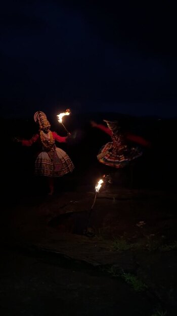 View of Kathakali performers with fire torches at night in Kochi India. View of Kathakali performers with fire torches at night in Kochi India.