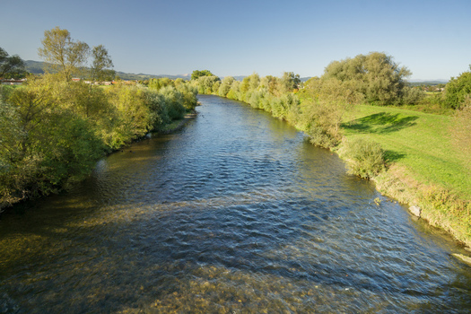 Aerial view of the Hron river flowing through lush green banks and trees in Sliac Banska Bystrica Regio Slovakia.