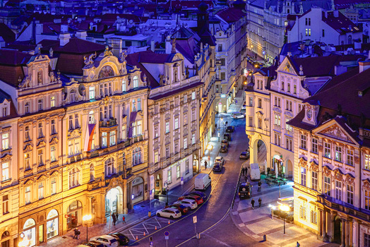 Aerial view of the historic streets of Old Town Prague at night featuring illuminated ornate facades parked cars and cobblestone roads in Prague Prague Czechia. Aerial view of the historic streets of Old Town Prague at night featuring illuminated ornate facades parked cars and cobblestone roads in Prague Prague Czechia.