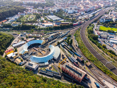 Aerial view of the historic Prague Vrsovice railway depot with its iconic roundhouse tracks and surrounding urban landscape in Prague Prague Czechia.