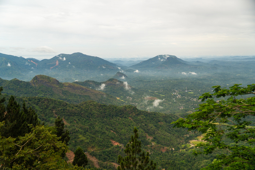 View of the lush mountainous landscape and misty valleys from the Ambuluwawa area in Gampola Central Province Sri Lanka. View of the lush mountainous landscape and misty valleys from the Ambuluwawa area in Gampola Central Province Sri Lanka.