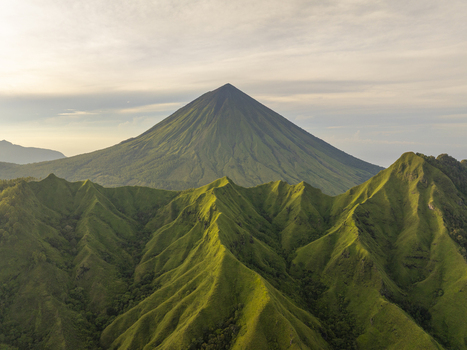 Aerial view of the volcanic Mount Inerie surrounded by lush green ridges and valleys Inerie Flores Indonesia. Aerial view of the volcanic Mount Inerie surrounded by lush green ridges and valleys Inerie Flores Indonesia.