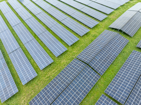Aerial view of rows of solar panels installed on a green field under bright daylight Aiglsbach Bavaria Germany.
