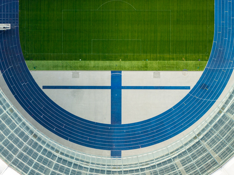 Berlin Germany 26 September 2026 Aerial view of Olympiastadion Berlin showing the vibrant blue running track and the lush green football pitch from a high angle.