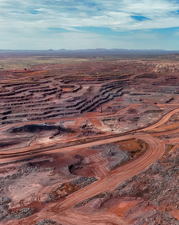Aerial view of an open pit mining operation featuring terraced excavation levels winding haul roads and red earth landscapes in Thabazimbi Limpopo South Africa. Aerial view of an open pit mining operation featuring terraced excavation levels winding haul roads and red earth landscapes in Thabazimbi Limpopo South Africa.