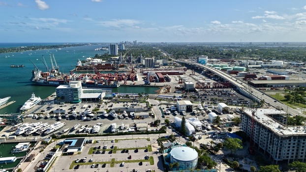 Aerial view of Riviera Beach Marina Village with cargo ships luxury yachts and the coastal skyline under a bright sky Riviera Beach Florida United States. Aerial view of Riviera Beach Marina Village with cargo ships luxury yachts and the coastal skyline under a bright sky Riviera Beach Florida United States.