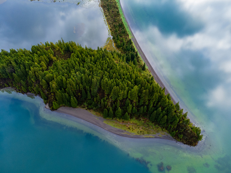 Aerial view of Lagoa do Fogo with its lush green forest and turquoise water reflecting soft clouds in Agua de Alto Azores Portugal. Aerial view of Lagoa do Fogo with its lush green forest and turquoise water reflecting soft clouds in Agua de Alto Azores Portugal.