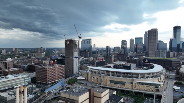 Aerial view of a city skyline dominated by skyscrapers and a stadium under a dramatic sky Minneapolis Minnesota United States.