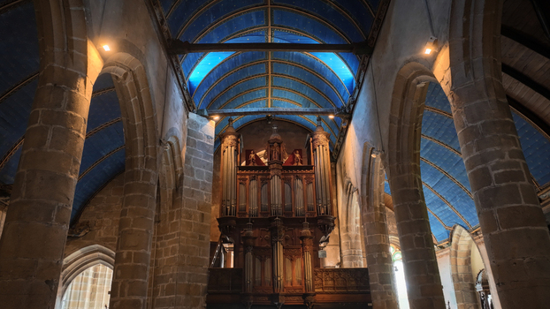 Aerial view of the interior of Eglise Saint Melaine de Morlaix featuring a blue vaulted ceiling with stars and stone pillars in Morlaix Bretagne France. Aerial view of the interior of Eglise Saint Melaine de Morlaix featuring a blue vaulted ceiling with stars and stone pillars in Morlaix Bretagne France.