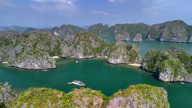 Aerial view of Lan Ha Bay limestone islands and boats Vietnam.