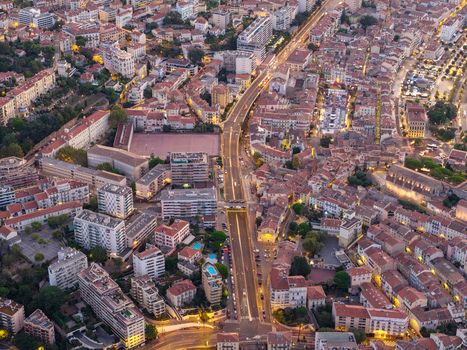 Aerial view of the urban landscape of Cannes at twilight with illuminated streets and dense residential architecture in Cannes Provence Alpes Cote d Azur France. Aerial view of the urban landscape of Cannes at twilight with illuminated streets and dense residential architecture in Cannes Provence Alpes Cote d Azur France.