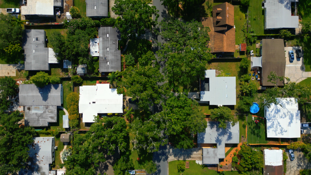 Aerial view of a residential neighborhood with houses lush green trees and a backyard swimming pool in Tampa Florida United States. Aerial view of a residential neighborhood with houses lush green trees and a backyard swimming pool in Tampa Florida United States.