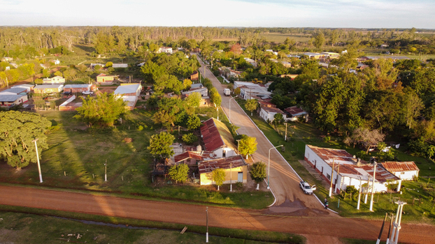Aerial view of the town of Guaviravi featuring rural houses dirt roads and lush green trees in Guaviravi Corrientes Province Argentina. Aerial view of the town of Guaviravi featuring rural houses dirt roads and lush green trees in Guaviravi Corrientes Province Argentina.