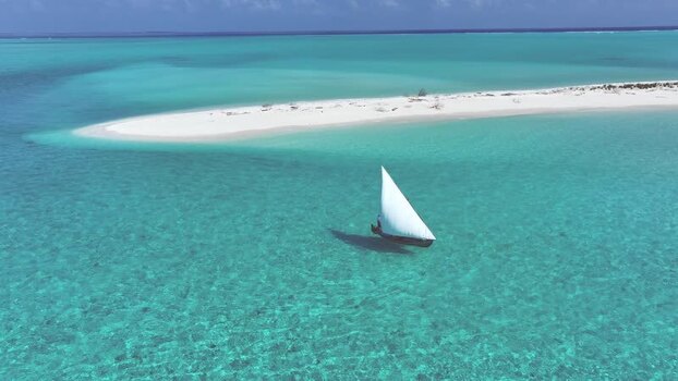 Aerial view of a traditional boat sailing near a sandbank Maldives. Aerial view of a traditional boat sailing near a sandbank Maldives.