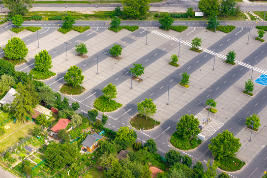 Aerial view of a large parking lot with marked spaces and green trees in Warsaw Masovian Voivodeship Poland. Aerial view of a large parking lot with marked spaces and green trees in Warsaw Masovian Voivodeship Poland.