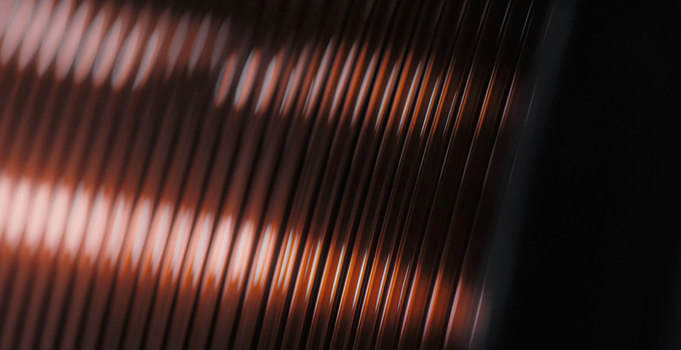 View of tightly wound copper wire on a spool showcasing the metallic texture and reflective surface in an industrial setting Buffalo New York United States. View of tightly wound copper wire on a spool showcasing the metallic texture and reflective surface in an industrial setting Buffalo New York United States.