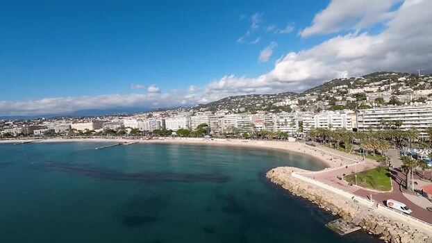 FPV aerial view of the coastline and beach in Cannes France.