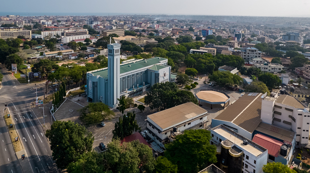 Aerial view of the Holy Spirit Cathedral surrounded by lush trees urban buildings and roads in Accra Greater Accra Region Ghana. Aerial view of the Holy Spirit Cathedral surrounded by lush trees urban buildings and roads in Accra Greater Accra Region Ghana.