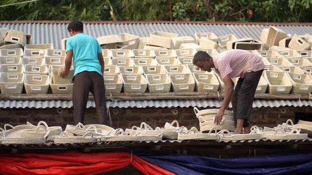 View of men organizing woven baskets in Bogura Bangladesh. View of men organizing woven baskets in Bogura Bangladesh.