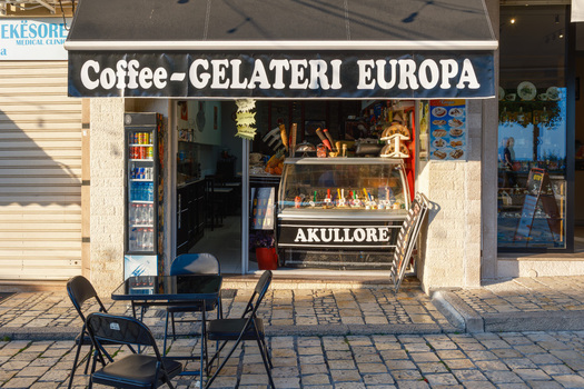 Kruje Albania 12 June 2026 View of the Coffee Gelateri Europa shopfront with outdoor seating on a cobblestone street in the historic town.