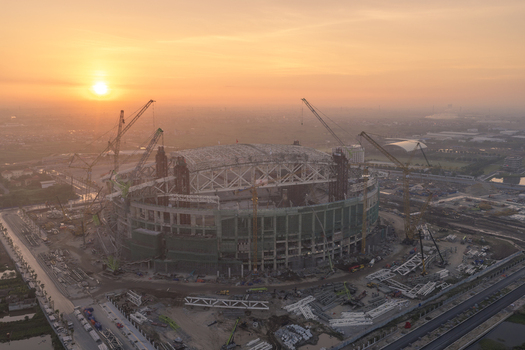 Aerial view of PVF Stadium under construction with multiple cranes and scaffolding at sunset in Hanoi Ha Noi Vietnam. Aerial view of PVF Stadium under construction with multiple cranes and scaffolding at sunset in Hanoi Ha Noi Vietnam.