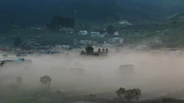 Aerial view of a misty village and mosque in Dieng Indonesia. Aerial view of a misty village and mosque in Dieng Indonesia.