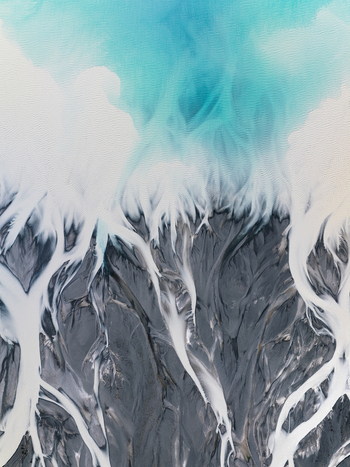 Aerial view of glacial rivers intertwine painting a surreal canvas of icy blue and stark white against the dark earth Lake Tekapo Canterbury Region New Zealand. Aerial view of glacial rivers intertwine painting a surreal canvas of icy blue and stark white against the dark earth Lake Tekapo Canterbury Region New Zealand.