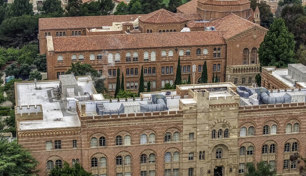 Aerial view of the historic red brick buildings of the UCLA Campus featuring intricate architectural details and surrounding lush green trees Westwood California United States.