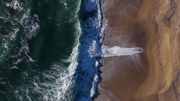 Aerial view of beach and ocean waves Portugal.